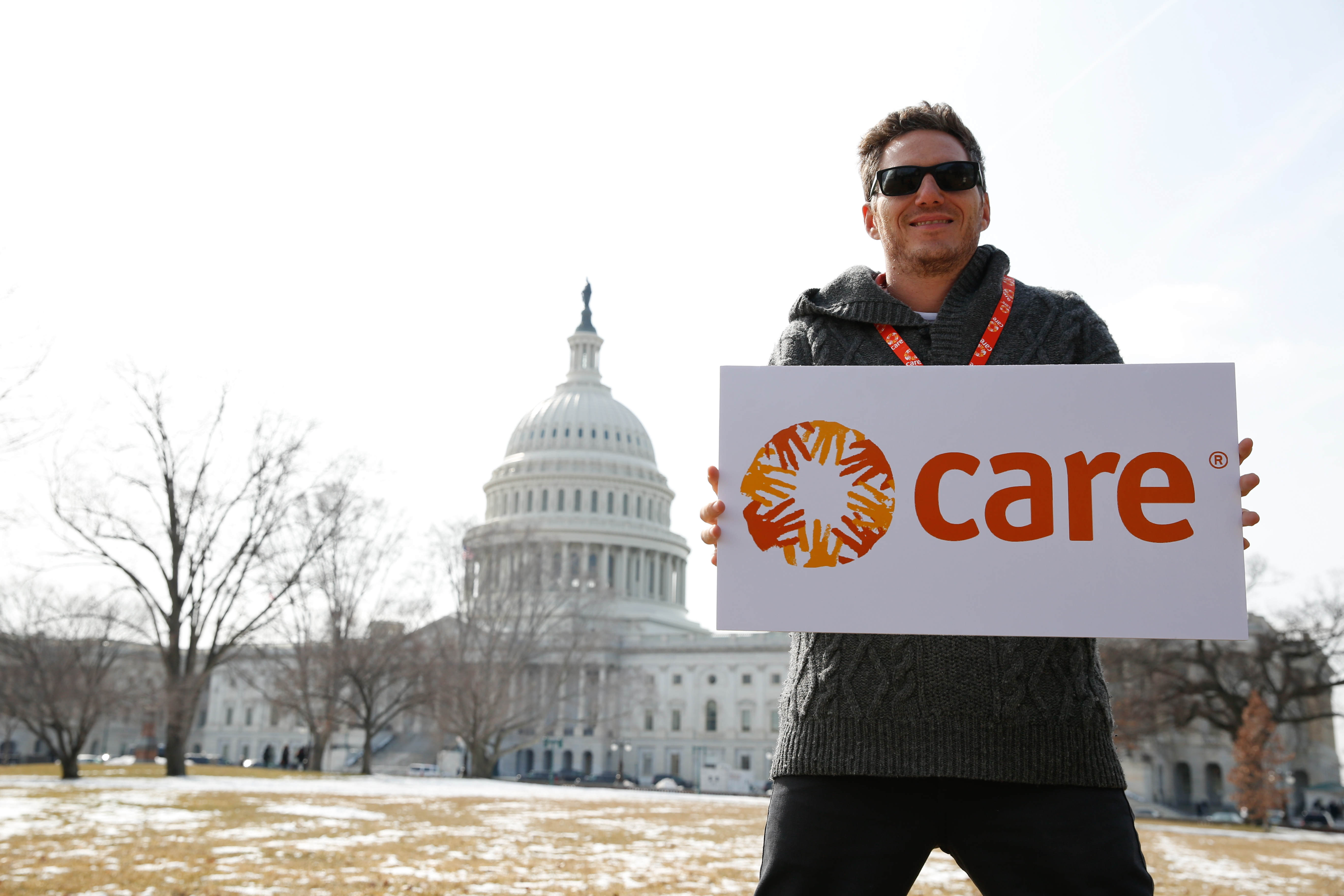 Spike Mendelsohn, chef, takes photos in front of the U.S. Capitol. CARE speakers, staff, board members and attendees of the 2014 CARE National Conference &amp; International Women&#039;s Day Celebration take pictures in front of the U.S. Capitol building, Washingt