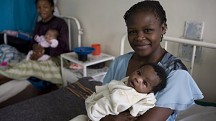 a woman holds a baby in a clinic