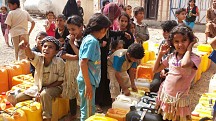 Children line up to collect water in Sanaa at water tank donated by CARE Foundation for Peace project. Water has become an extremely scarce resource since the conflict started and water is completely cut off in some cities and neighborhoods. Youth from th