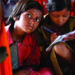 Indian children study in an open hut. Credit: [Ami Vitale/ EFAReport]