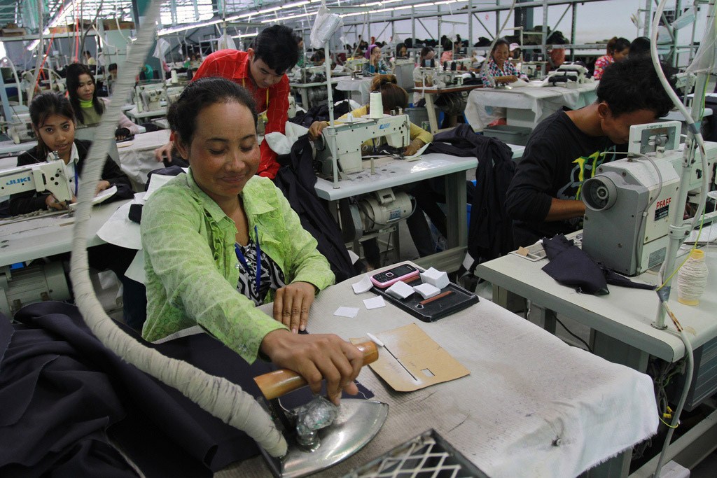 Photo: A woman irons fabric at a garments factory at the Sihanoukville Special Economic Zone, Phnom Penh, Cambodia. Photo: World Bank/Chhor Sokunthea