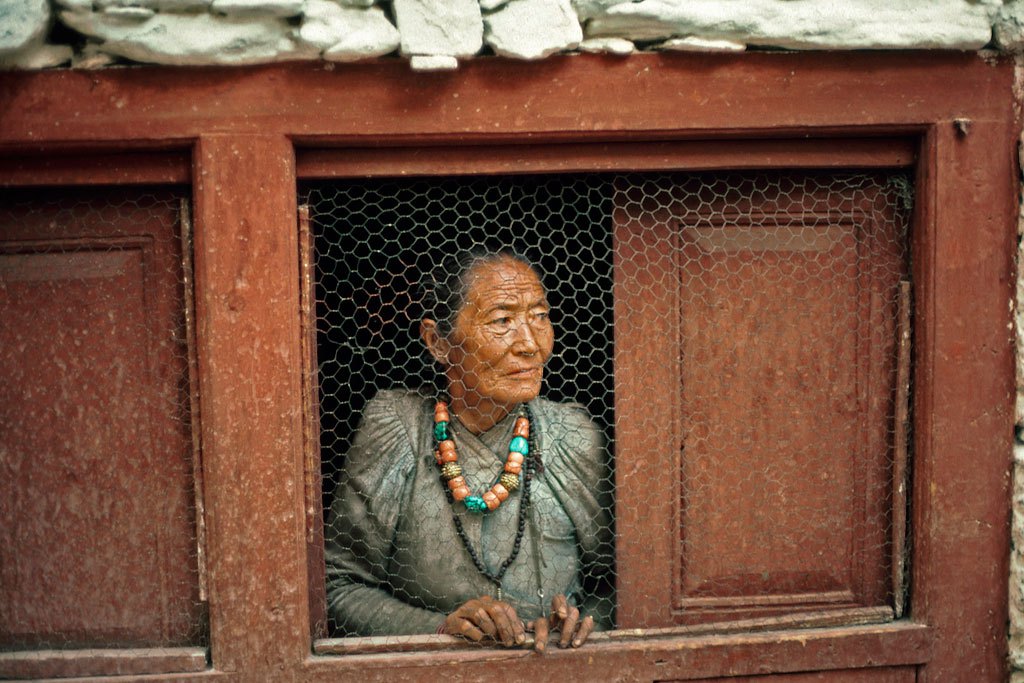 Photo: An old woman at her window in a Nepalese village. UN Photo/John Isaac