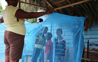 Children surrounded by protective malaria net in the Dominican Republic. Photo: WHO/PAHO