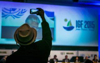 Photo: A man takes a photo on the first day of the Internet Governance Forum in Joao Pessoa, Brazil.