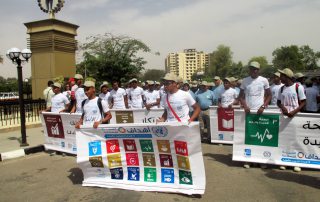 Participants at an SDG event in Aswan, Egypt, hold an SDG banner.