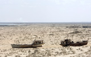 A view of rusted, abandoned ships in Muynak, Uzebkistan, a former port city whose population has declined precipitously with the rapid recession of the Aral Sea, shown in this April 2010 photo. UN Photo/Eskinder Debebe