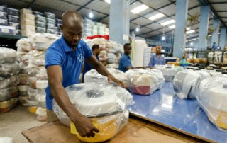 Factory workers package products at Decorplast, a manufacturer and regional exporter of injectionmoulded plastic goods in Ghana. Panos/ Nyani Quarmyne
