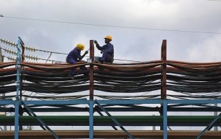 Photo: Workers maintain the thermal power station at Takoradi, Ghana. (Photo by World Bank/Jonathan Ernst)