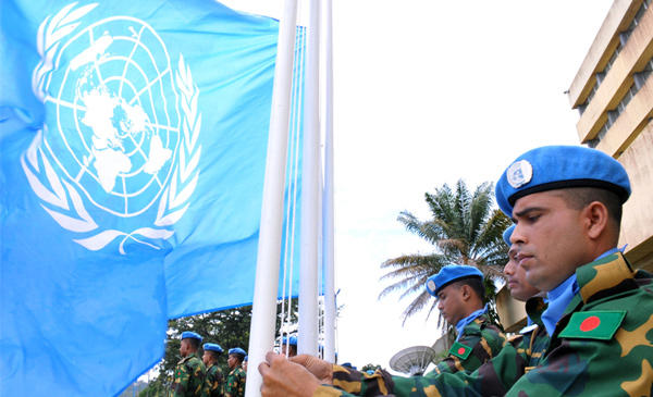 Peacekeepers raise the UN flag