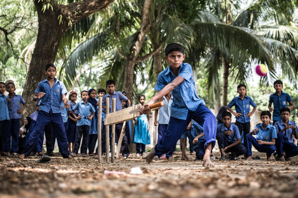 Rakib Hosain Sabbir, aged 9, a fourth grade student bats during a cricket game at Labsha Government Primary School in Satkhira Sadar, Bangladesh. Photo: UNICEF/Ashley Gilbertson VII