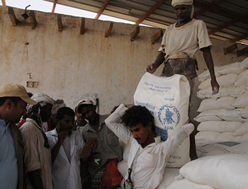 Men unload a truck at a WFP distribution centre