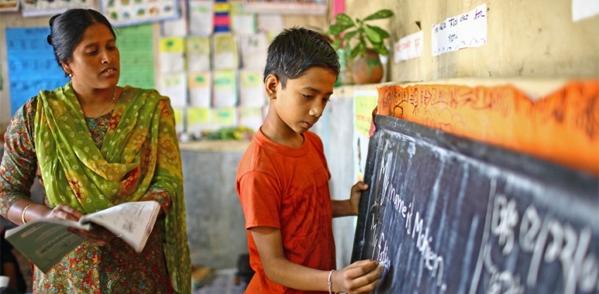 A teacher and student at a school in India. Photo: UNESCO/GMR Akash