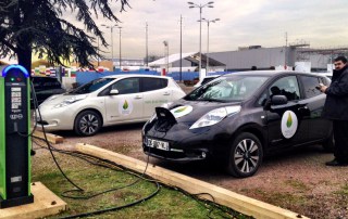 Recharging electric cars sit in the COP21 parking lot.