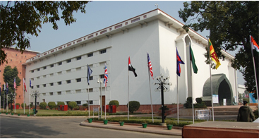 Outside of the Vigyan Bhavan building with different flags