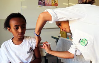 Photo: In Sao Paulo, Brazil, a young girl receives the HPV cervical cancer vaccine, given at public and private schools throughout the county and in the 36,000 vaccination centers of the national health system in March 2014.