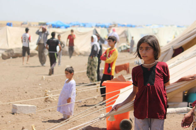 Yazidi refugees, including several children, go about their lives in Nawrouz refugee camp, approximately 40 kilometres from the Syrian border with Iraq. Photo: UNICEF/Razan Rashidi