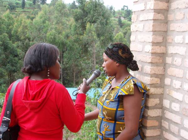 Emma Claude, Radio Salus producer, interviewing a woman coffee farmer