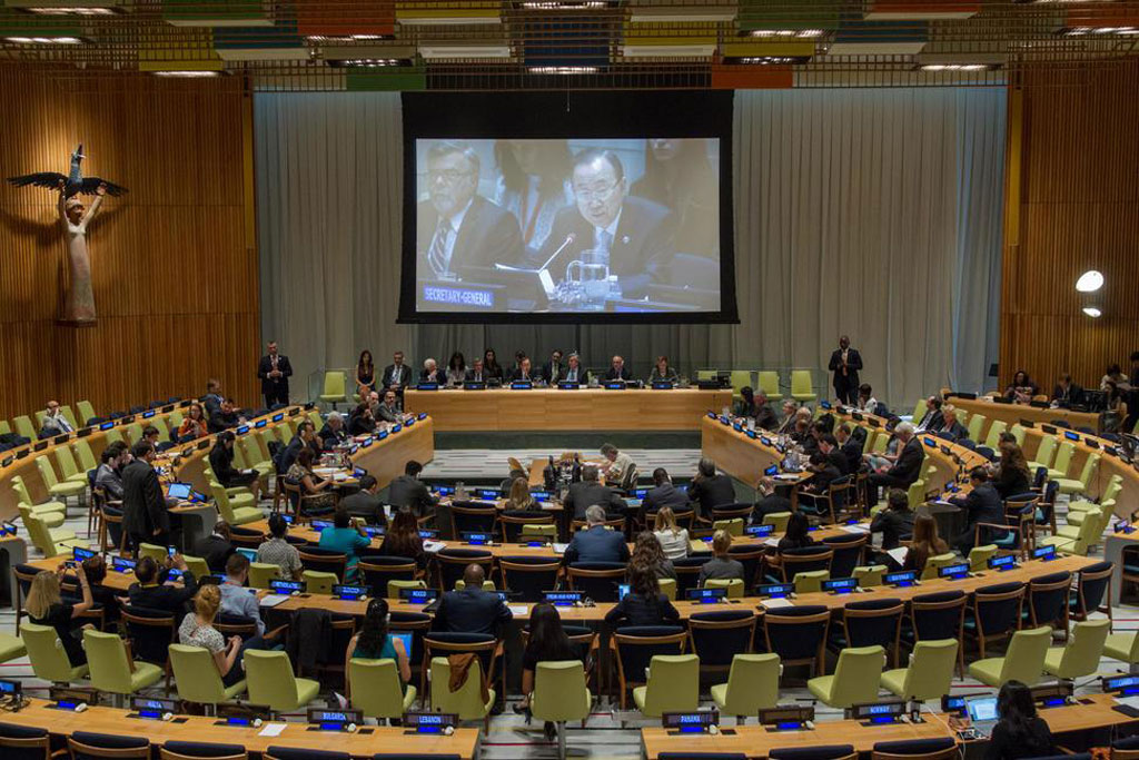 Secretary-General Ban Ki-moon (screen) delivers remarks at formal open consultations at UN Headquarters in New York on the 2016 Comprehensive Review of the implementation of Security Council resolution 1540 (2004). UN Photo/JC McIlwaine