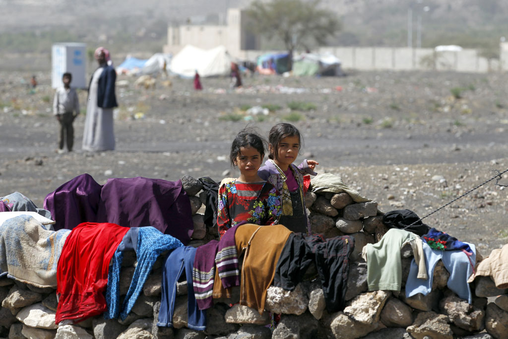 In Yemen, internally displaced children stand outside their family tent after the family fled their home in Saada province and found refuge in Darwin camp, in the northern province of Amran. PhotO: UNHCR/Yahya Arhab
