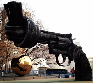 photo of a sculpture of a gun with the barrel twisted into a knot