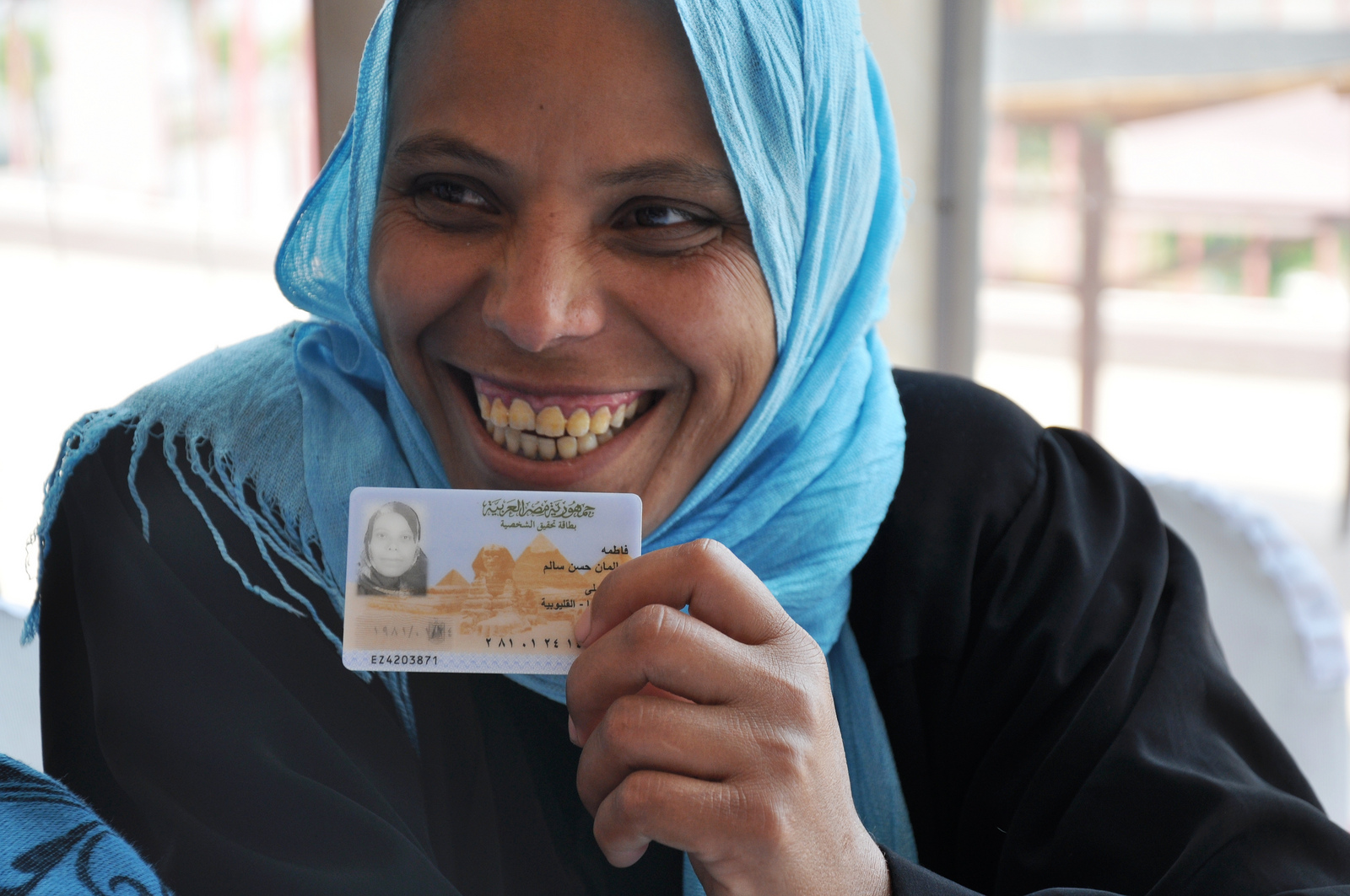 Having an official identification card is key to the rule of law. In this photo, an Egyptian woman holds her card.