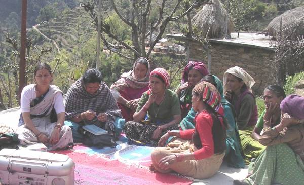 India - Raibar women listen to a radio programme