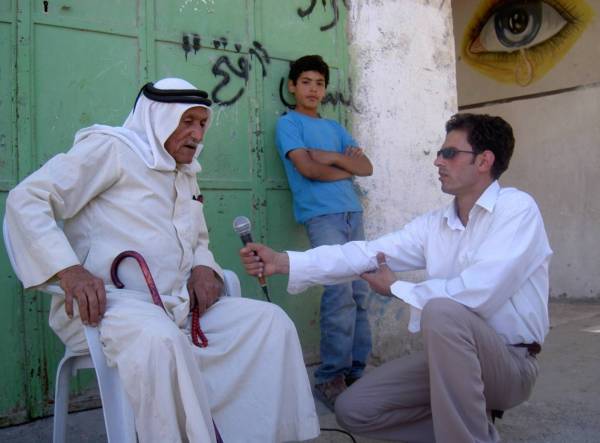 Palestine - Journalist interviewing community member in Hebron