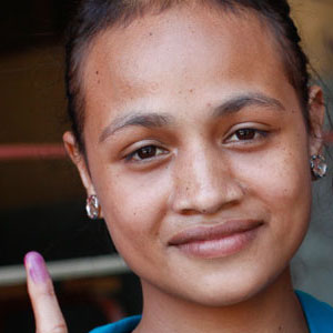 A voter displays proof of having exercised her voice at the ballot box in Timor-Leste’s parliamentary elections. 