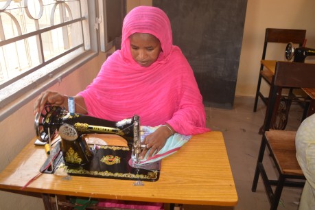 A young woman learns sewing at Soufouroulaye youth camp. The training is part of a regional programme to strengthen human security and resilience in the Sahel.