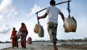 Above, people carry drinking water in Bangladesh