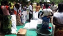 People gather at Mikolongo school in Chikwawa district, Malawi, to receive rations of maize, pulses, oil and fortified corn soya blend from WFP to prevent malnutrition. 