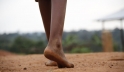 On 29 May, Centia, 12, walks barefoot across dusty ground in Kirundo Province, Burundi. Photo credit: UNICEF/UNI186074/Nijimbere