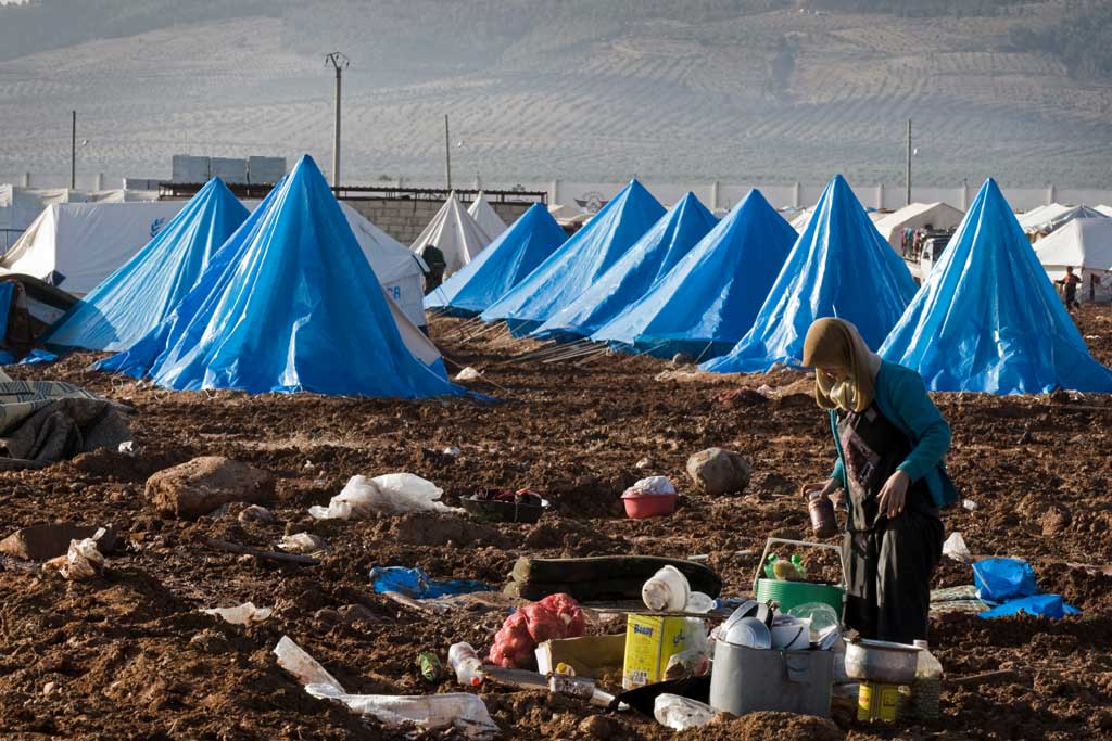 Une femme prépare un repas dans le camp de déplacés de Bab Al Salame, près de la frontière avec la Turquie, dans le gouvernorat d’Alep, en Syrie (janvier 2014). Photo OCHA