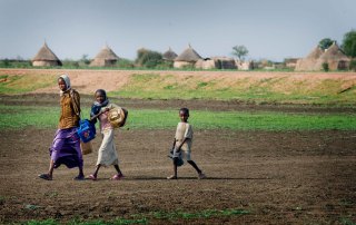 Photo: Children carry jerrycans and other containers on their way to collect water in El Khatmia Village, Gadaref state, Sudan.