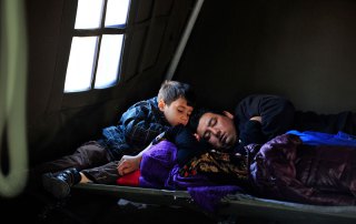 Photo: In Croatia, a refugee family rests in the UNICEF-supported Family Area at the reception centre in Opatovac.