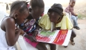 Girls in Voinjama, Liberia, look at a poster that displays information on Ebola.   Photo: UNICEF/Liberia/Jallanzo