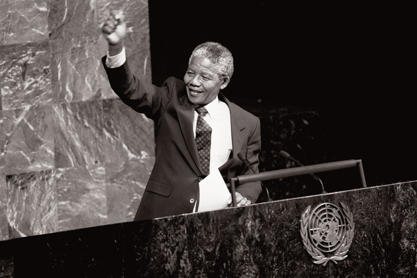 Nelson Mandela, then Deputy President of the African National Congress of South Africa, raises his fist in the air while addressing the Special Committee Against Apartheid in the General Assembly Hall. UN Photo/P. Sudhakaran