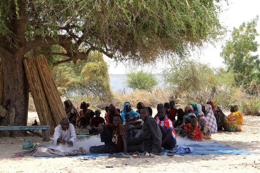 In Tagal, Chad, an IDP community meets under a tree. More than 100 persons had to flee from one of the small islands in Lake Chad after Boko Haram insurgents attacked their village. Photo: OCHA/Ivo Brandau