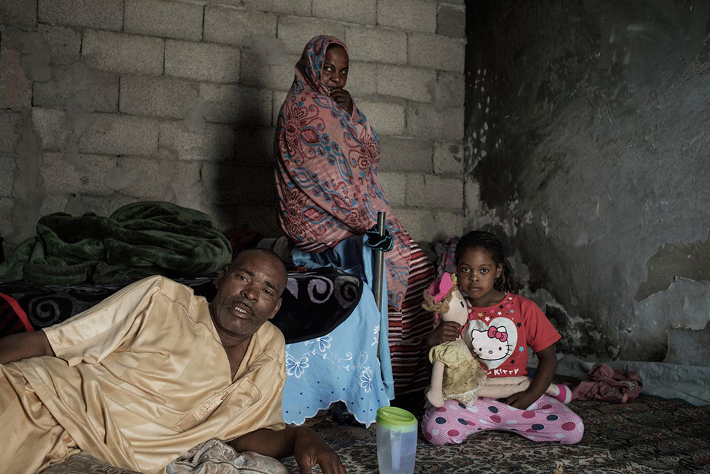Abd Al Ali, his wife, Masouda, and his 6-year-old daughter, Nour, live on the outskirts of Tripoli, Libya. His family survives with help from their neighbours. Abd Al Ali, who has two wives and 16 children, has a disability and diabetes and is unable to work. Photo: UNICEF/ Romenzi