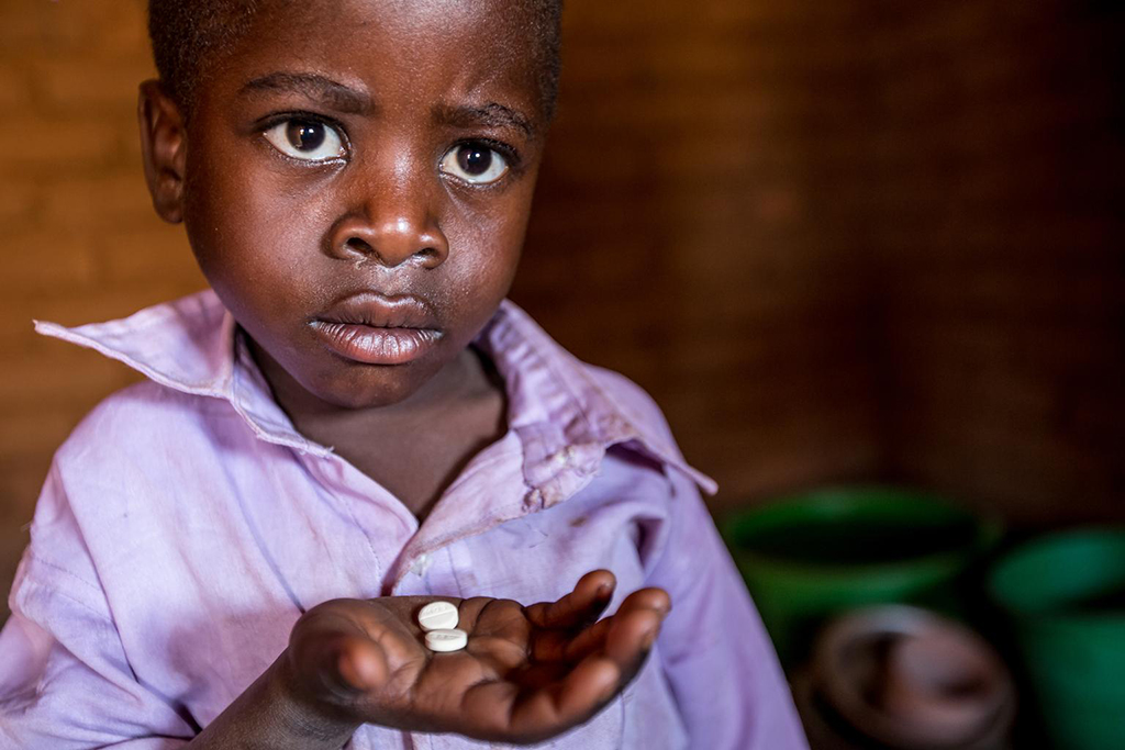 Photographed in August, Longezo is 3 and living with HIV in Nkhuloawe Village, Malawi. Here is taking his medication. His life was saved when Bizwick visited his home and discovered he was very ill and in need of medical attention. Photo: UNICEF/UNI201846/Schermbrucker