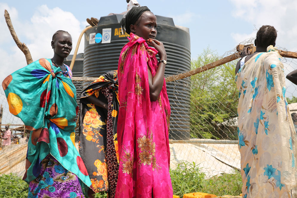 Women displaced by fighting in Juba, South Sudan, queue to fill containers with water after UNICEF delivered 100,000 litres of safe water to the site, where many residents had resorted drinking from a nearby stream. UNICEF/UN025202/Irwin
