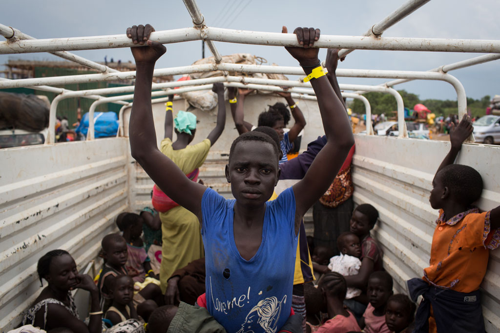 Refugees from South Sudan are transported from Elego town to the Numanzi Transit Center where meals and temporary accommodation are provided by UNHCR in Adjumani, northern Uganda. Photo: UNHCR/Will Swanson