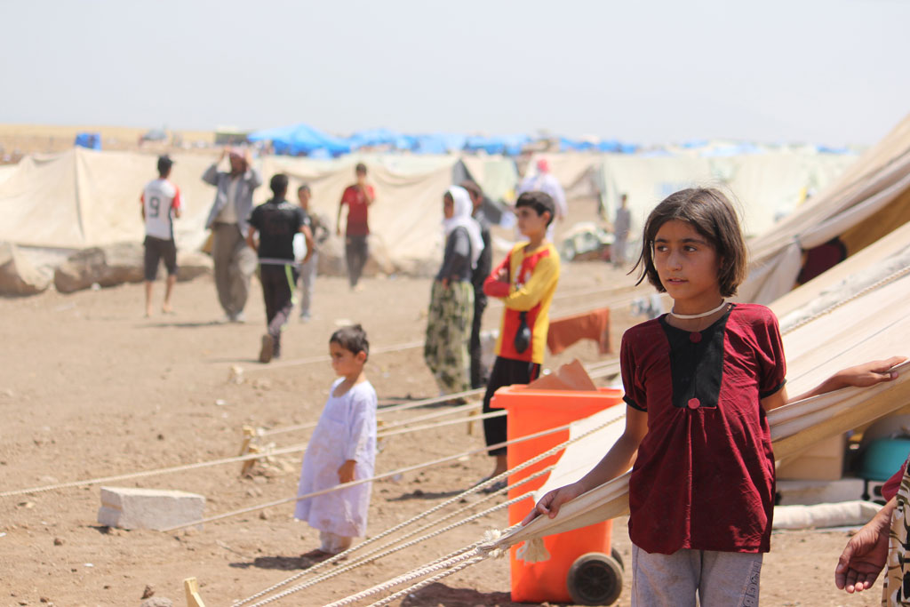 Yazidi refugees, including several children, go about their lives in Nawrouz refugee camp, approximately 40 kilometres from the Syrian border with Iraq. Photo: UNICEF/Razan Rashidi