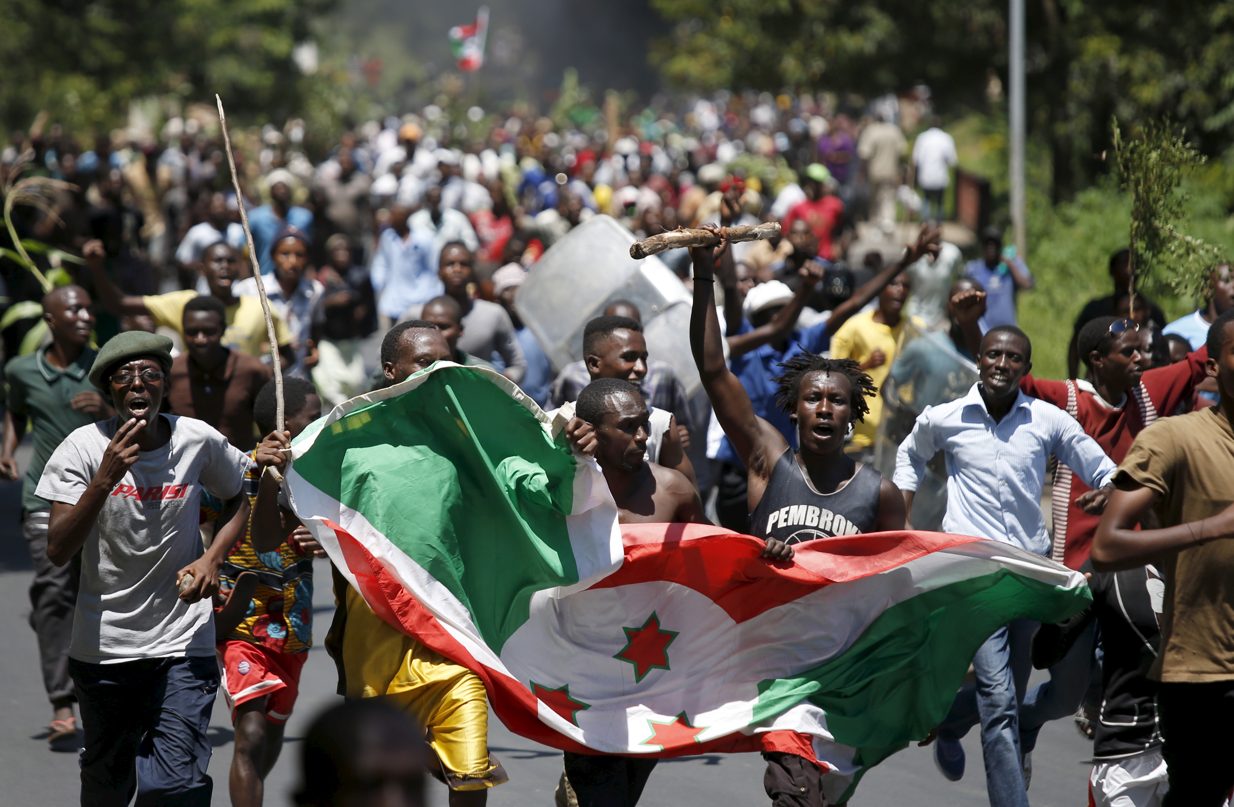 Demonstrators carry a Burundi flag during a protest in Bujumbura, Burundi. Photo: Reuters/G. Tomasevic 