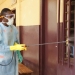 A volunteer disinfecting the hospital of Tahouay in Conakry, Guinea.  Photo: Afreecom/Idrissa Soumaré