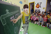 China, May 2011: A teacher introduces ways to save water in daily life to children in a kindergarten in Yinchuan (northern China). A theme activity featuring water-saving was held here to mark the national urban water conservation week.