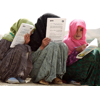 Three young girls in the Bam Sarai village in Bamyan province, Afghanistan, preparing for exams. UN Photo/Shehzad Noorani