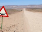 Flood warning sign along a gravel road, Namibia