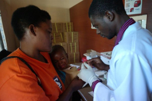 Mother getting her child checked for Malaria after his HIV test. Educated mothers are better informed about specific diseases and therefore can take measures to prevent them. ©UNICEF/Christine Nesbitt 2011