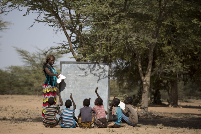 Ewesit, teaching under a tree in a mobile school in Turkana, Kenya. Photo credit:UNESCO/Karel Prinsloo